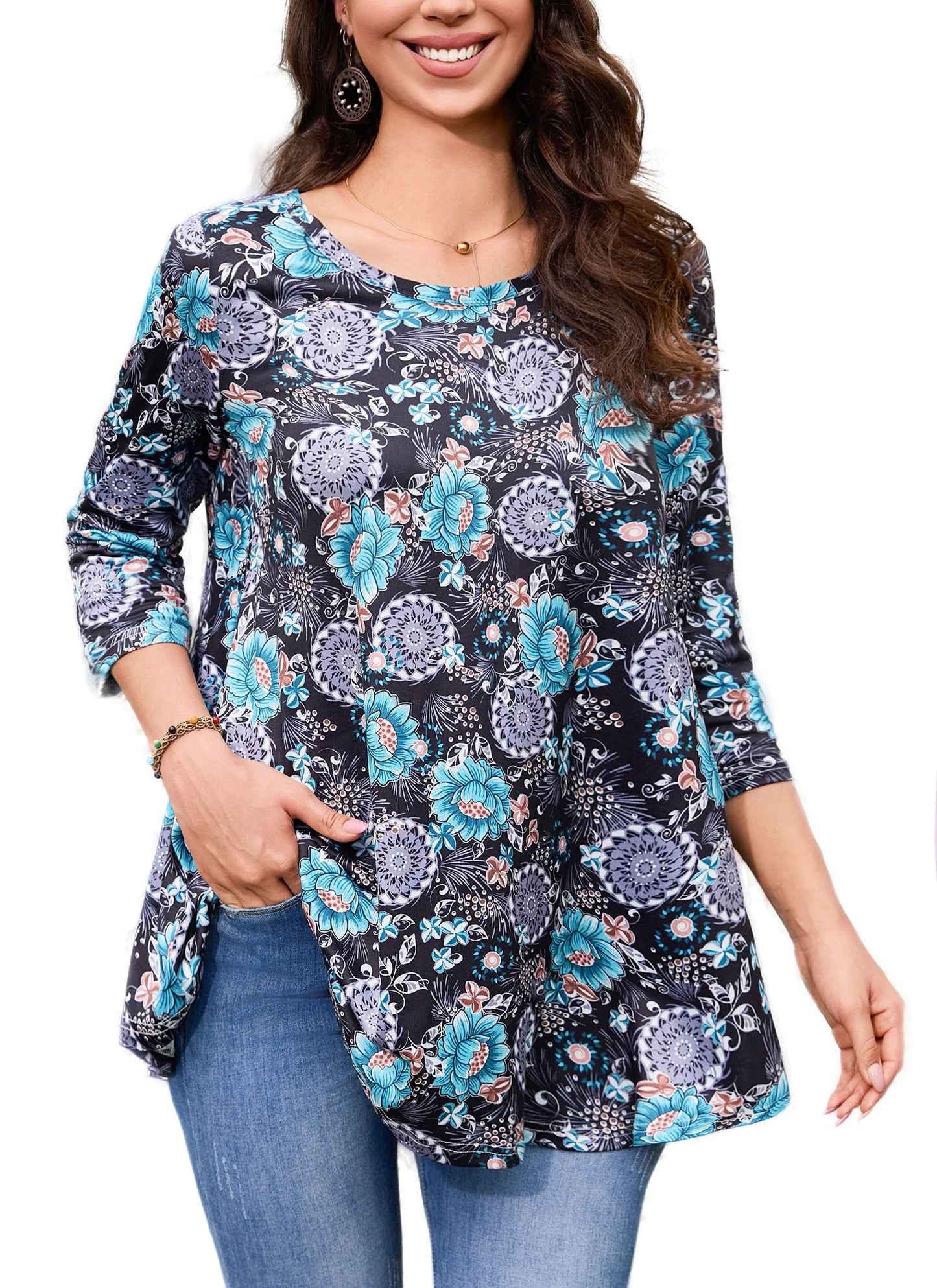 Woman wearing a floral patterned long-sleeve top with blue jeans on a white background