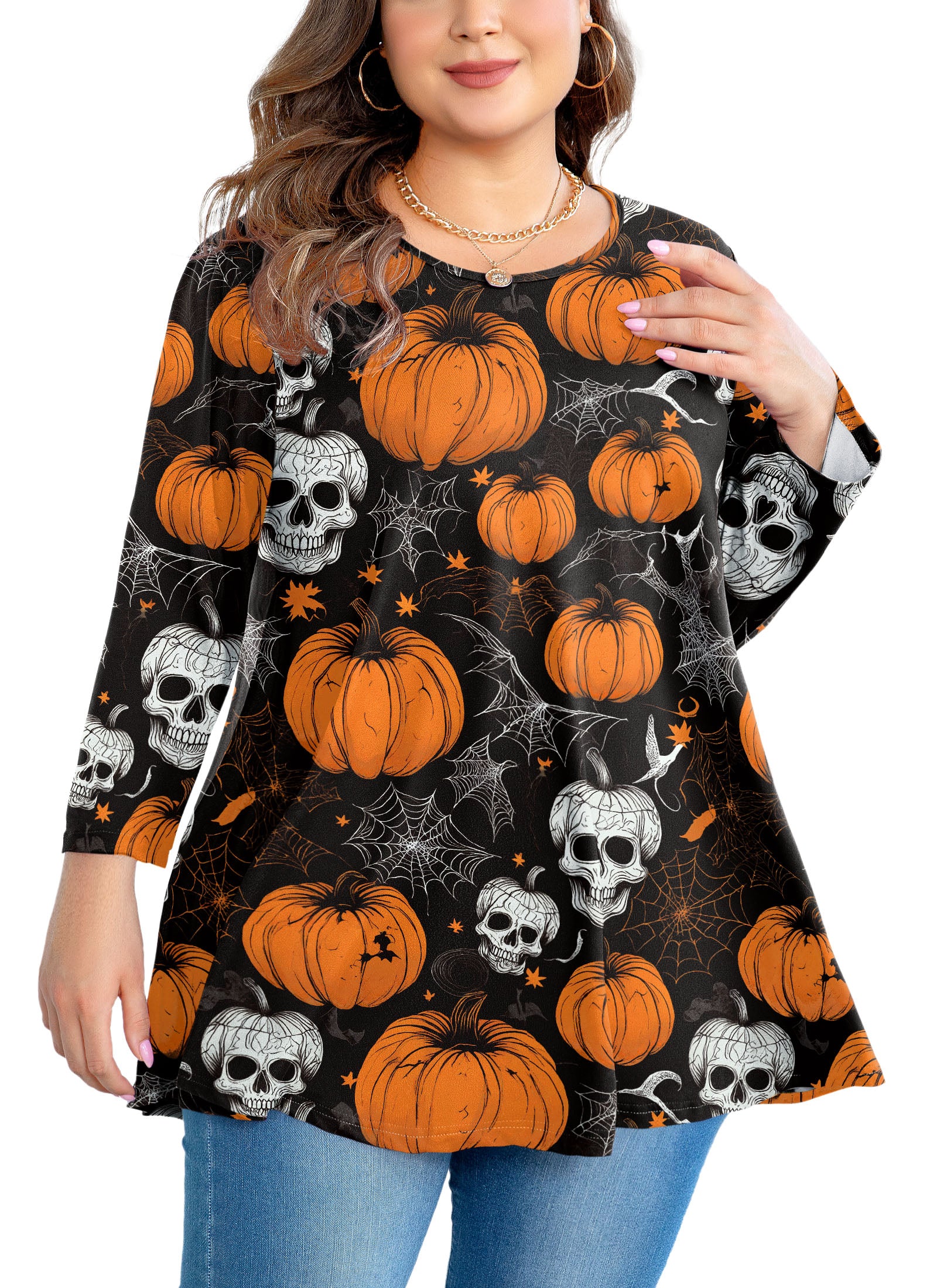 Woman wearing a Halloween-themed tunic with pumpkins and skulls.