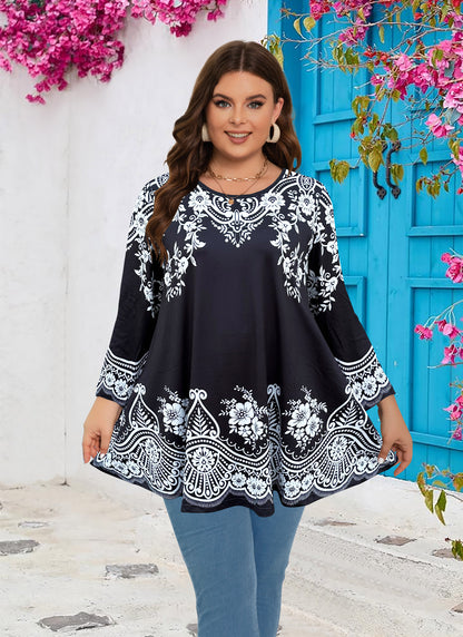 Woman wearing a black and white patterned dress with a blue door and pink flowers in the background